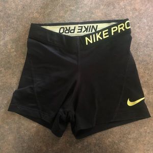 Black Nike pro with neon yellow detail